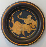 Woman_playing_kottabos-plate-by_the_Bryn_Mawr_Painter-Attic_Greek,_c480_BC.red-figure_terracotta-Sackler_Museum-Harvard_University